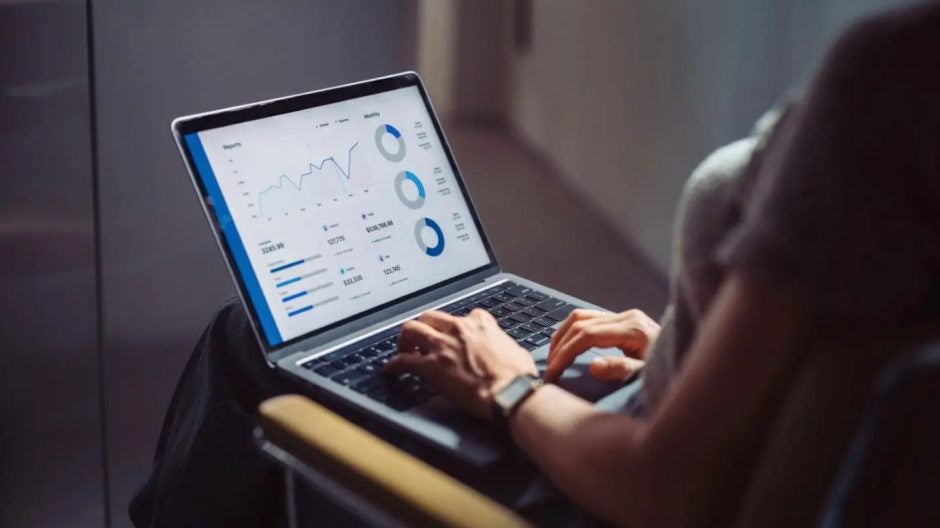 Woman analyzing hospital data on a laptop